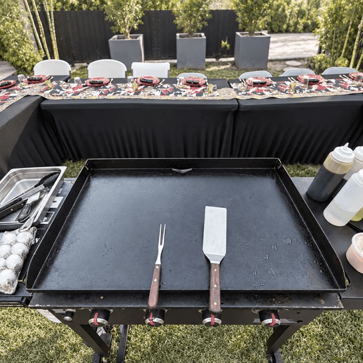 Professional teppanyaki flat-top grill ready for a private hibachi dinner